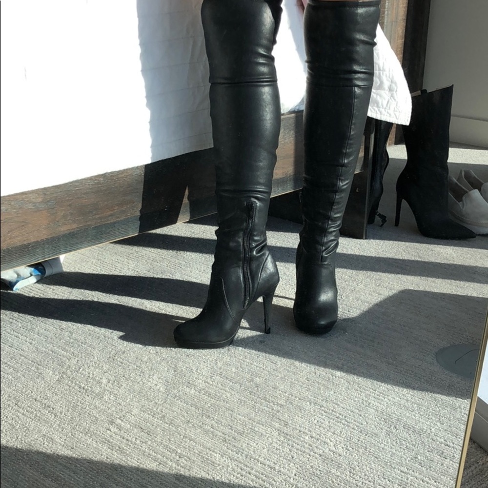 Thigh high black leather heeled boots